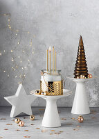 Advent wreath in a glass with golden candles on a white pedestal