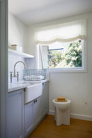 Kitchen area with marble worktop and window overlooking the greenery