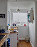 Small kitchen with maritime decorations and lake view