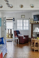 Living room with red leather armchair and maritime accents