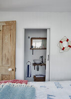 Maritime guest room with white-panelled wall and lifebuoy decor
