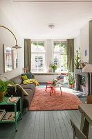 Bright living room with green curtains and pink carpet