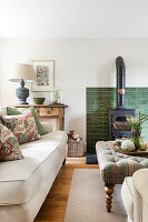 Upholstered furniture in front of green tiled fireplace wall