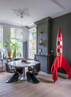 Dining room with black wall, balloon light and decorative rocket