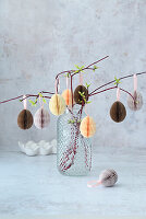 Easter eggs made from folded paper on twigs
