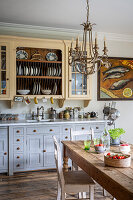 Rustic country kitchen with wooden dining table and chandelier