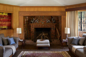 Classic living room with brick fireplace and grey sofas