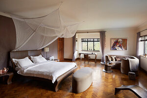 Spacious bedroom with canopy and parquet flooring