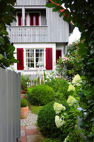Entrance to front garden with boxwood and hydrangeas