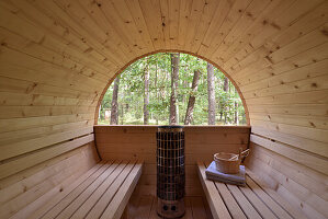 Wooden outdoor sauna with a view of the forest