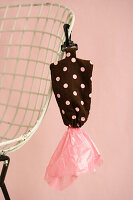 Bag dispenser with dots for dog waste bags on wire chair