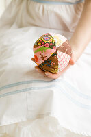 Homemade patchwork ball in women's hands