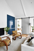 Living room with blue built-in wardrobe and rattan chairs