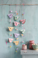 DIY bird garland made from painted cardboard rolls and cord