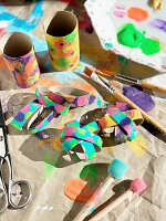 Colourful DIY flowers made from painted cardboard rolls with button decorations