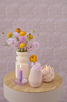 Still life with purple hyacinths, ranunculus and candles on a wooden table