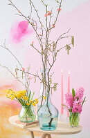 Spring table decoration with daffodils (Narcissus), hyacinths (Hyacinthus) and flowering twigs