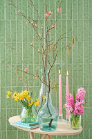 Spring table decoration with daffodils (Narcissus), hyacinths (Hyacinthus) and flowering twigs