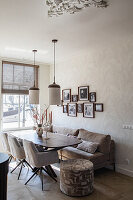 Bright dining room with upholstered sofa and chairs with wooden table and murals