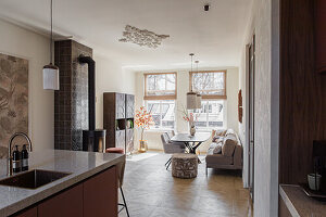 Modern living and dining area with fireplace and large windows