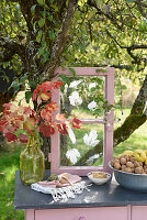 Autumn garden table with leaf print on decorative window and nuts