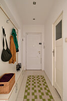 Narrow hallway with wardrobe and patterned runner