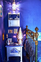Metal bed and bedside table in blue, oriental bedroom