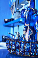 Bathroom with blue pearl jewellery and glass bottle decor