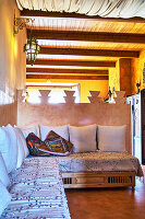 Sitting area with Moroccan lanterns and wooden beamed ceiling