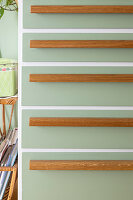 Green kitchen cabinet with wooden elements in retro style