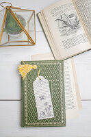 Homemade bookmark made from a book page and tracing paper on an old-fashioned book