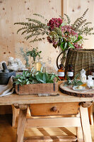Antique wooden table with mortar, fresh sage and ingredients for natural cosmetics