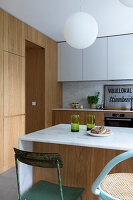 Modern kitchen with wooden fronts and marble kitchen island