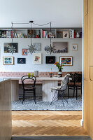 Dining area with star lights, gallery wall and open wall shelves