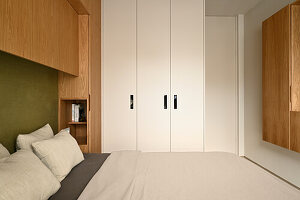 Bedroom with white fitted wardrobe and modern wood panelling