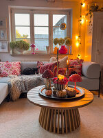 Cosy living room with autumnal decorations and fairy lights