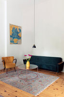Retro living room with velvet sofa, armchair and map