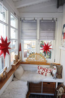 Small winter garden with cosy seating area, Christmas decorations and candle arch