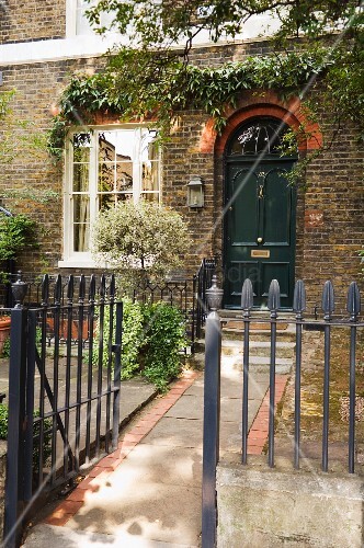 Georgian-style, English house with wrought iron fence around front ...