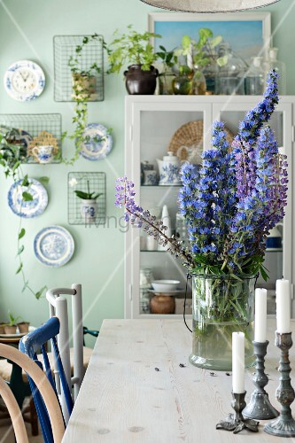 Candlesticks And Blue Flowers In Glass Buy Image 11402898
