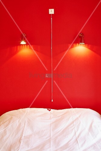 Bed Below Spotlights On Bright Red Wall Buy Image