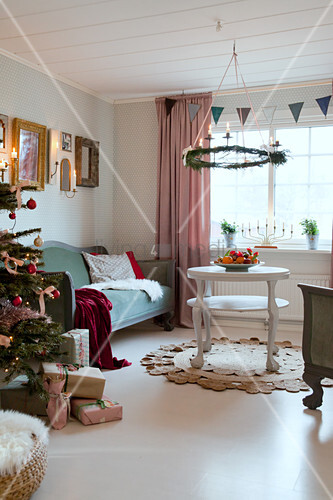 Wreath Hanging Over Couch In Festive Image