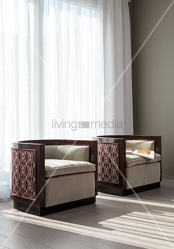 Two Designer Armchairs In Front Of Buy Image 12352650