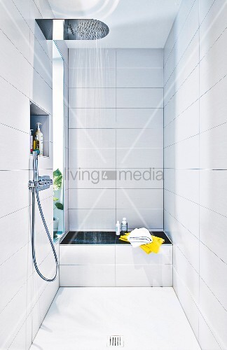 A White Tiled Shower Area With A Bench Buy Image 12404780