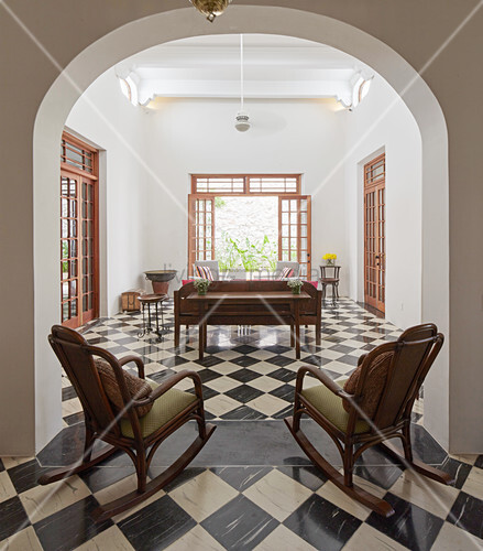 Two Rocking Chairs In Arched Doorway Image