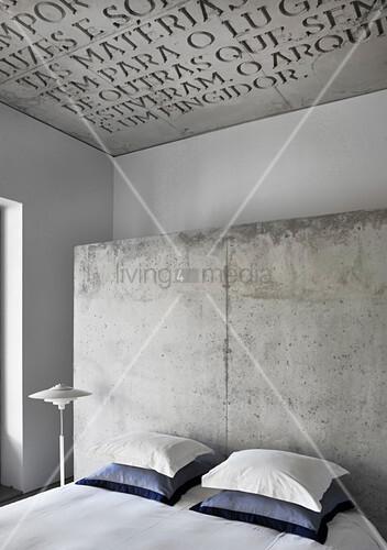 Double Bed With Pillows Against Concrete Buy Image