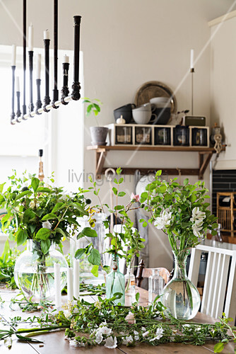 Vases Of Flowers And Twigs On Table In Buy Image