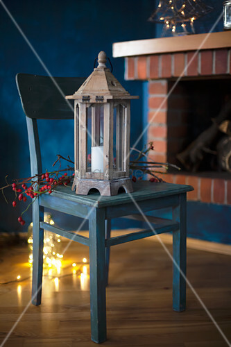 Lantern And Branch Of Berries On Wooden Buy Image