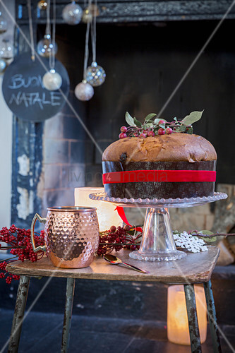 Panettone on table in front of festively decorated fireplace