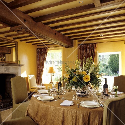 A Table Laid In A Room With A Wood Beam Buy Image 00706930
